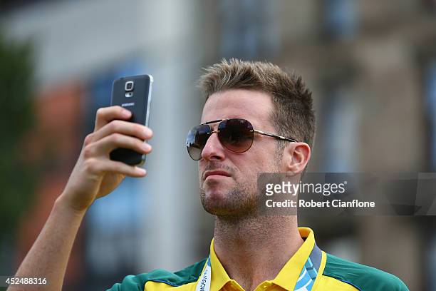 Australian swimmer James Magnussen takes a photo on his phone during the Australian Commonwealth Games official team reception at the Kelvin Grove...