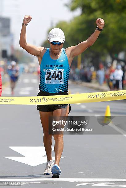 Cristian Chocho of Ecuador crosses the finish line in 50k walk race as part of the XVII Bolivarian Games Trujillo 2013 at Juan Pablo Street on...