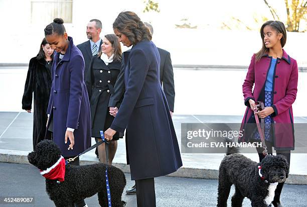 First Lady Michelle Obama with dog Sunny, daughters Malia and Sasha , welcome the Official White House Christmas Tree to the White House November 29,...