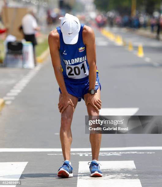 Exhausted Ferney Rojas of Colombia crosses the finish line in 50k walk race as part of the XVII Bolivarian Games Trujillo 2013 at Juan Pablo Street...