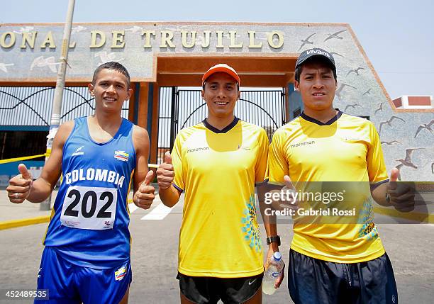 Athletes Jorge Ruiz of Colombia , Cristian Chocho of Ecuador and Jonnathan Caceres of Ecuador pose for a picture after competing in 50k walk race as...