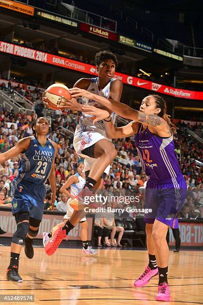 Angel McCoughtry of the Eastern Conference All-Stars drives against Brittney Griner of hte Western Conference All-Stars during the 2014 Boost Mobile...