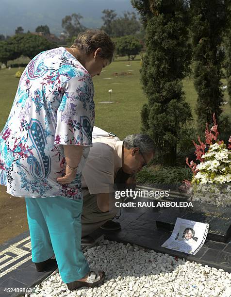 The sister of the Colombian drug lord Pablo Escobar, Luz Maria Escobar and her housband Leonardo Arteaga, visit Escobar's tomb on November 29, 2013...