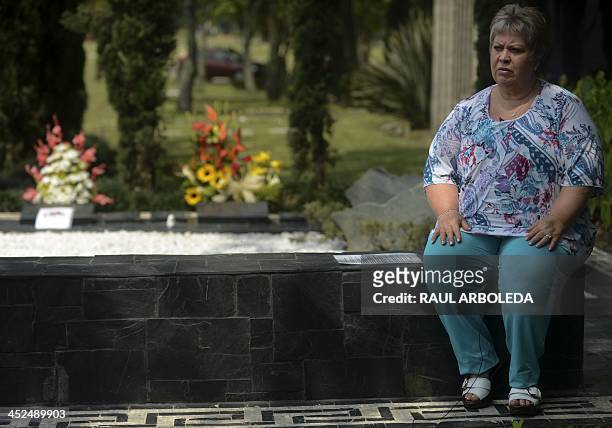The sister of the Colombian drug lord Pablo Escobar, Luz Maria Escobar and her housband Leonardo Arteaga , stand next to Escobar's tomb on November...
