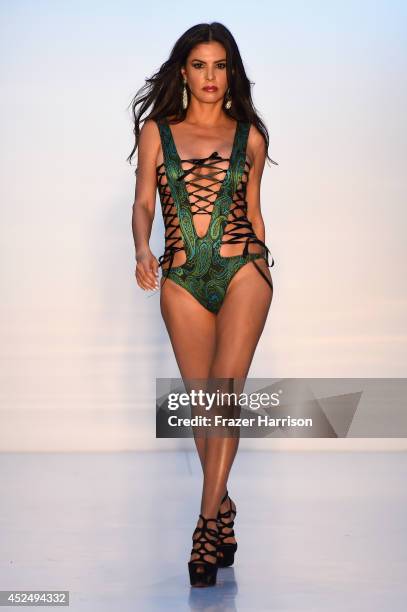 Personality Adriana De Moura walks the runway at the A.Z Araujo show during Mercedes-Benz Fashion Week Swim 2015 at The Raleigh on July 21, 2014 in...