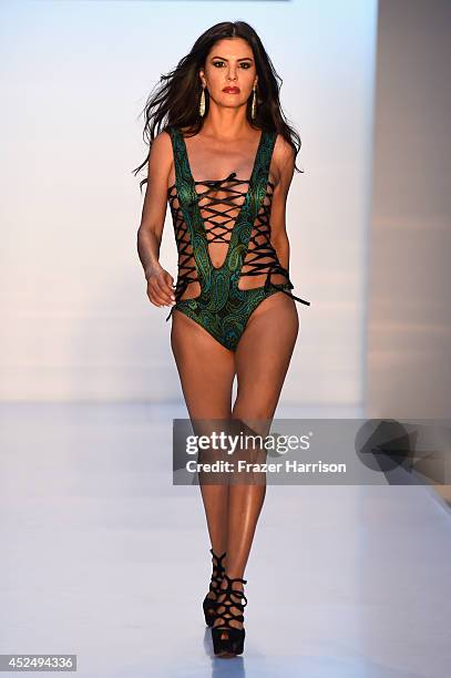 Personality Adriana De Moura walks the runway at the A.Z Araujo show during Mercedes-Benz Fashion Week Swim 2015 at The Raleigh on July 21, 2014 in...