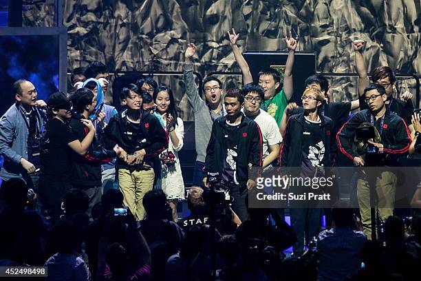 Members of team Newbee celebrate with their freinds and family on stage following their win at The International DOTA 2 Championships on July 21,...