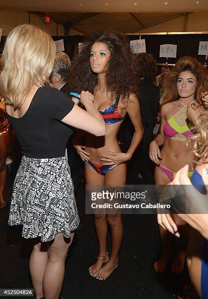 Model prepares backstage at Indah fashion show during Mercedes-Benz Fashion Week Swim 2015 at Cabana Grande at the Raleigh Hotel on July 21, 2014 in...