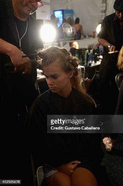 Model prepares backstage at Indah fashion show during Mercedes-Benz Fashion Week Swim 2015 at Cabana Grande at the Raleigh Hotel on July 21, 2014 in...