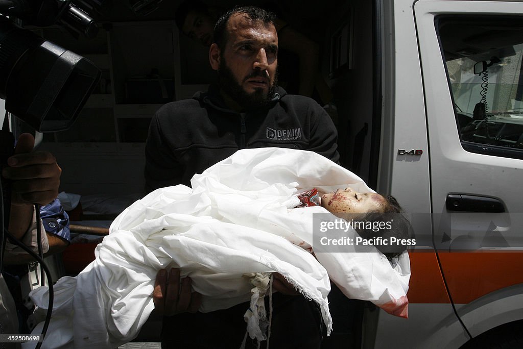 A Palestinian man carries the body of Dalal Siam, a five-...