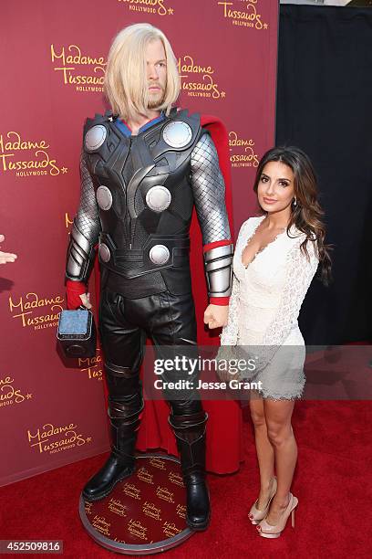 Actress Mikaela Hoover poses alongside a Madame Tussauds Hollywood MARVEL wax figure during the "Guardians of The Galaxy" premiere at the Dolby...