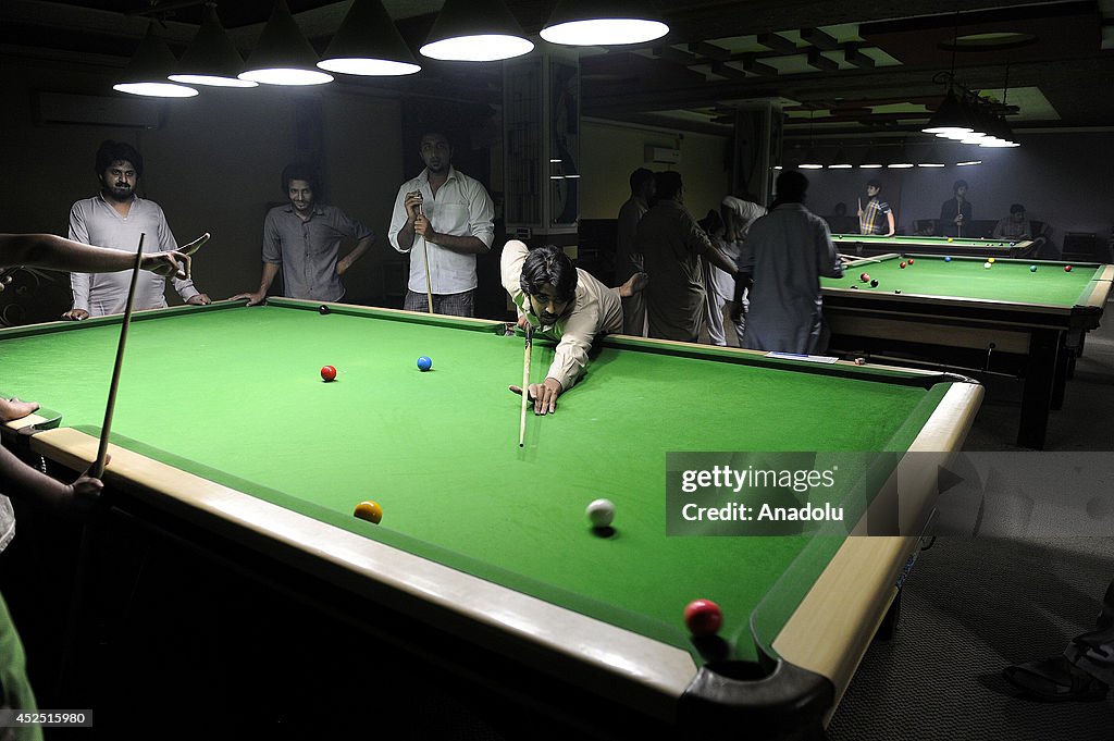 Pakistani teens having fun with playing billards