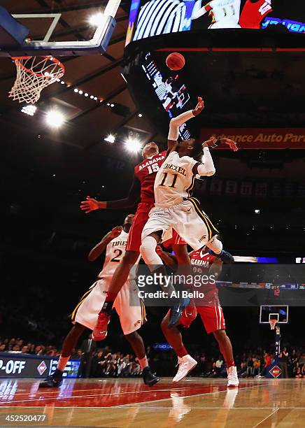 Nick Jacobs of the Alabama Crimson Tide and Tavon Allen of the Drexel Dragons battle for a rebound during their consolation game of the NIT Season...