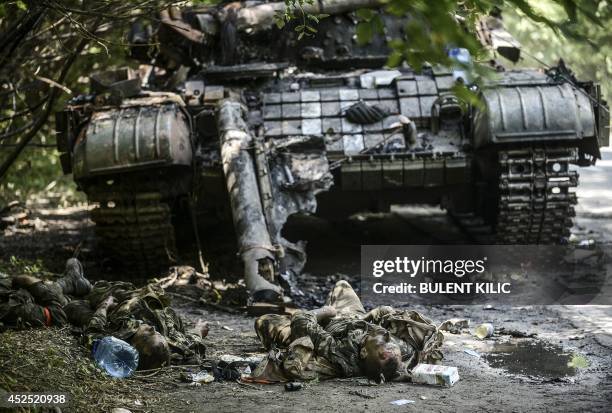 Bodies of crew members lie next to a destroyed Ukrainian tank in the northern outskirts of city of Donetsk, on July 22, 2014. Terrified civilians...