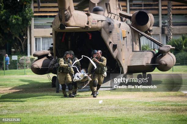 An Israeli soldier injured in combat is rushed to the emergecy room as the militery Helicopter lands in Soroka hospital on July 22, 2014 in...