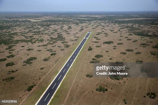 An airstrip lies on the King Ranch near the U.S.-Mexico border on July 21, 2014 near Falfurrias, Texas. Thousands of immigrants, many of them minors...