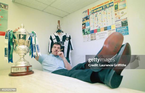 Notts County mananger Sam Allardyce celebrates the clubs success for the 1997-98 season with a cigar and the League trophy at Meadow Lane on May 1,...