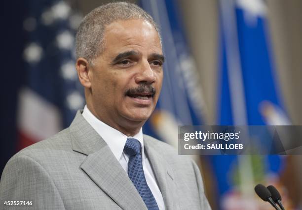 Attorney General Eric Holder speaks during a Naturalization Ceremony at the Justice Department in Washington, DC, July 22, 2014. Seventy people from...