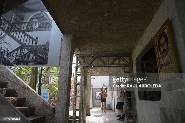 Visitors walk at Colombian drug trafficker Pablo Escobar's damaged mansion at the Napoles Ranch theme park in the Puerto Triunfo municipality,...