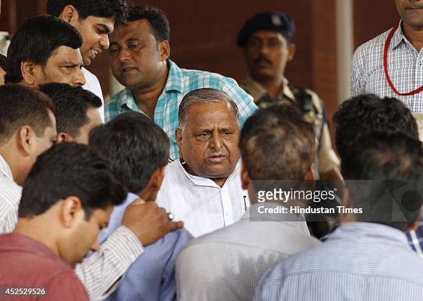 Samajwadi Party chief Mulayam Singh Yadav surrounded by journalists at Parliament house as he comes out after attending budget session on July 22,...