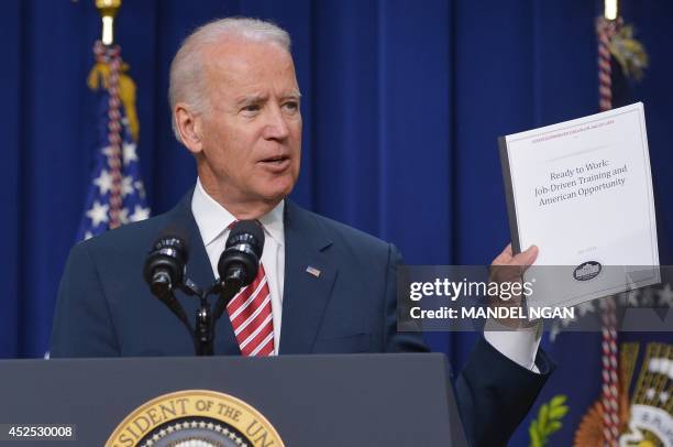 Vice President Joe Biden holds up a document as he speaks during a signing ceremony for H.R. 803, the Workforce Innovation and Opportunity Act, on...