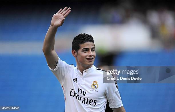 James Rodriguez waves to fans during his unveiling as a new Real Madrid player at the Santaigo Bernabeu stadium on July 22, 2014 in Madrid, Spain....