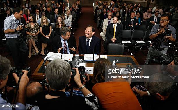Robert McDonald , President Obama's nominee to be the Secretary of Veterans Affairs, laughs while talking with Sen. Sherrod Brown prior to McDonald's...