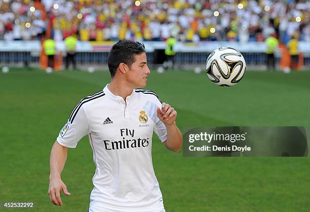 James Rodriguez controls the ball during his unveiling as a new Real Madrid player at the Santaigo Bernabeu stadium on July 22, 2014 in Madrid,...