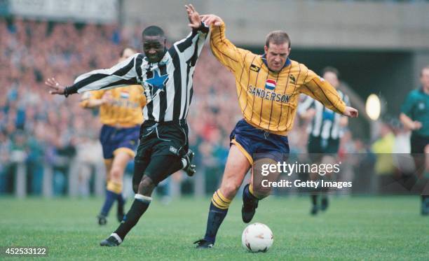 Newcastle forward Andy Cole battles with Peter Atherton during the FA Premiership match between Newcastle United and Sheffield Wednesday at St James'...
