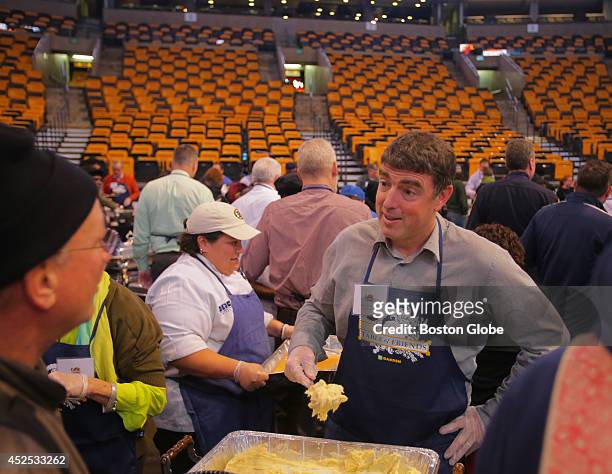 Boston Celtics' Managing Partner and Governor Wyc Grousbeck dishes up mashed potatoes at a free Thanksgiving dinner in TD Garden. TD Garden's...