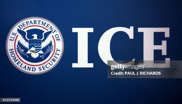 The Immigration and Customs Enforcement seal is seen before a press conference discussing ongoing enforcement efforts to combat human smuggling along...