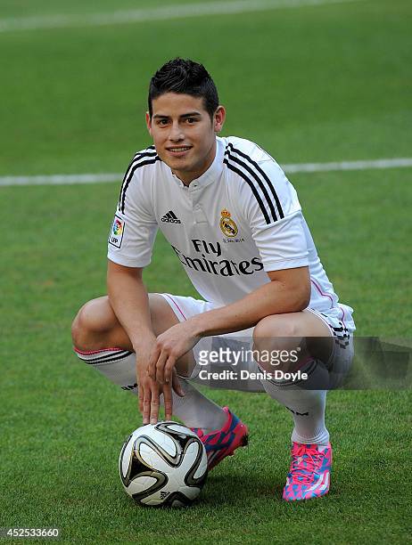 James Rodriguez poses for photographers during his unveiling as a new Real Madrid player at the Santaigo Bernabeu stadium on July 22, 2014 in Madrid,...