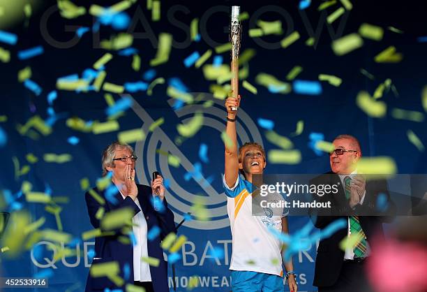 Batonbearer 142 Allison Curbishley holds up the Glasgow 2014 Queen's Baton in Queen's Park on July 22, 2014 in Glasgow, Scotland. Scotland is nation...