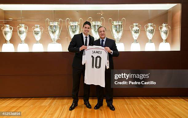 President of Real Madrid Florentino Perez pose with James Rodriguez during his official unveiling as a new Real Madrid player at Estadio Santiago...