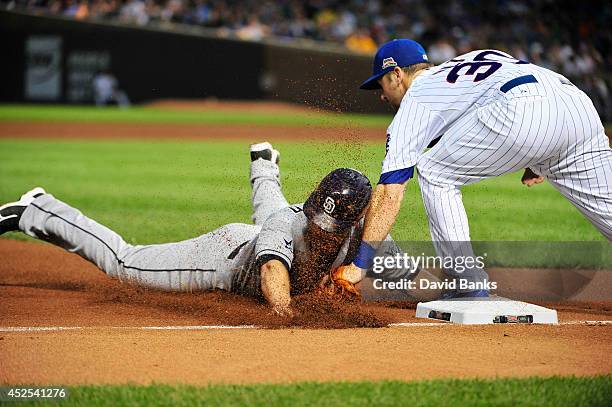 Brooks Conrad of the San Diego Padres is tagged out at third base by Mike Olt of the Chicago Cubs during the fifth inning on July 22, 2014 at Wrigley...