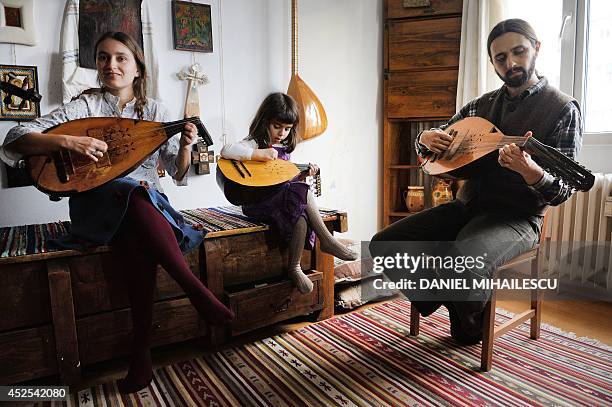 Beatrice Iordan , wife of Florin Iordan , ethnomusicologist at the Museum of the Romanian Peasant in Bucharest plays cobza together with their...