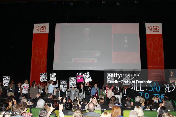 Protesters disrupt former U.S. President Bill Clinton as he addresses the 20th International AIDS Conference at The Melbourne Convention and...