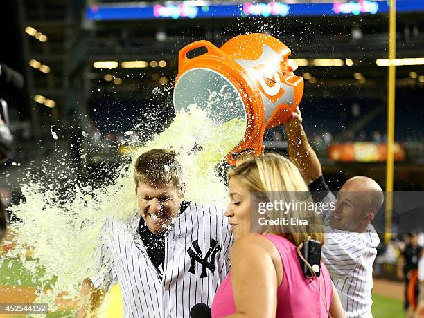 Chase Headley of the New York Yankees gets a gatorade bath by teammate Brett Gardner after the game against the Texas Rangers on July 23, 2014 at...