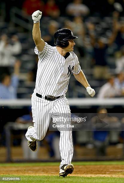 Chase Headley of the New York Yankees celebrates after he drove in the game winning run in the bottom of the 14th inning against the Texas Rangers on...