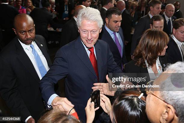 Former U.S. President Bill Clinton greets conference attendees as he leaves the 20th International AIDS Conference at The Melbourne Convention and...