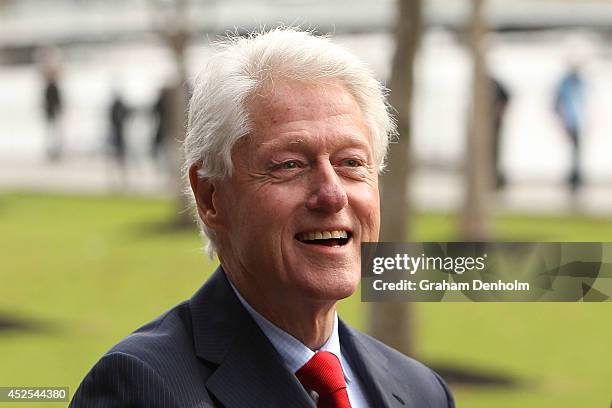 Former U.S. President Bill Clinton smiles as he leaves the 20th International AIDS Conference at The Melbourne Convention and Exhibition Centre on...