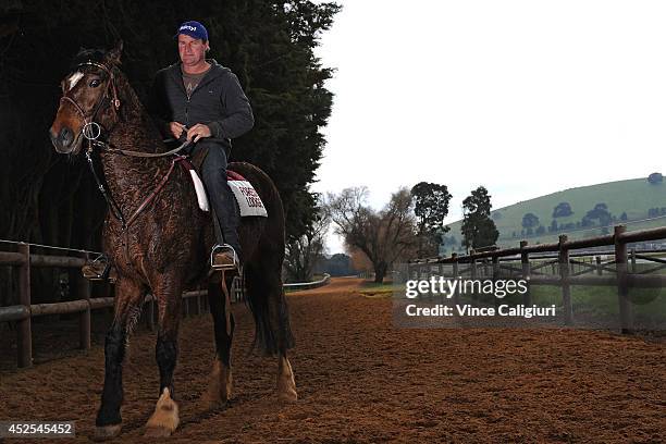 Trainer Darren Weir poses aboard his pony Bart after a Ballarat trackwork session at Ballarat Turf Club on July 23, 2014 in Ballarat, Australia.