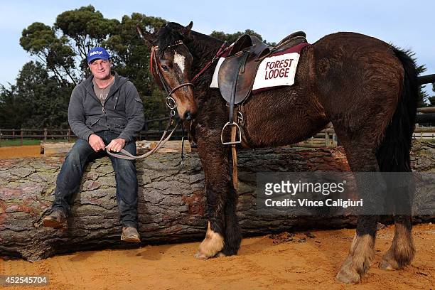 Trainer Darren Weir poses with his pony Bart after a Ballarat trackwork session at Ballarat Turf Club on July 23, 2014 in Ballarat, Australia.