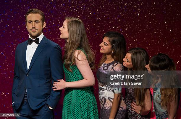 Fans queue to see the new waxwork as Madame Tussauds unveil their new Ryan Gosling wax figure at Madame Tussauds on July 23, 2014 in London, England.