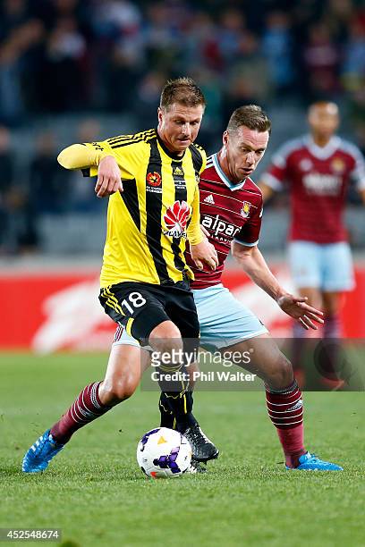 Ben Sigmund of the Phoenix is put under pressure from Kevin Nolan of West Ham during the Football United New Zealand Tour match between the...