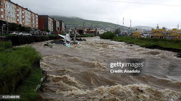 Plane, displayed in a museum, is adrift in flood water, damaged the roads, buildings and residential areas in Magadan, Russia on July 23, 2014.