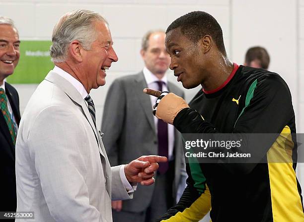 Prince Charles, Prince of Wales shares a joke with a member of the Jamaican Commonwealth Boxing Team as he visits the Emirates Arena and Chris Hoy...