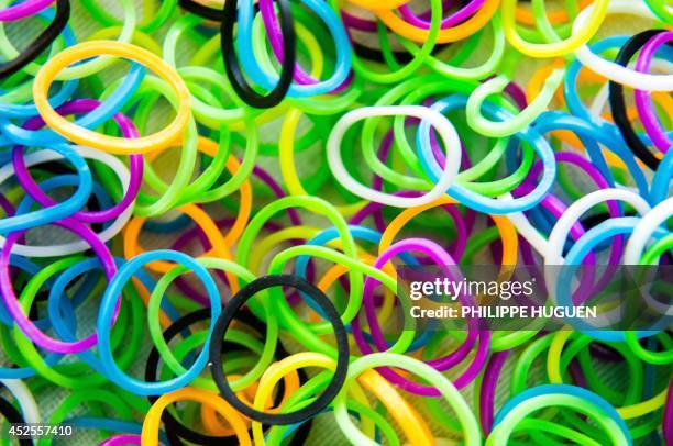 Photo taken on July 23, 2014 in Lille, northern France, shows coloured small elastic bands used to make "Rainbow Loom" bracelets, a new fashion...