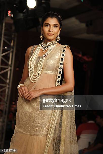 Model walks down the ramp during grand finale by Shree Raj Mahal Jewellers as a part of India Couture Week 2014 at the Taj Palace Hotel on July 20,...