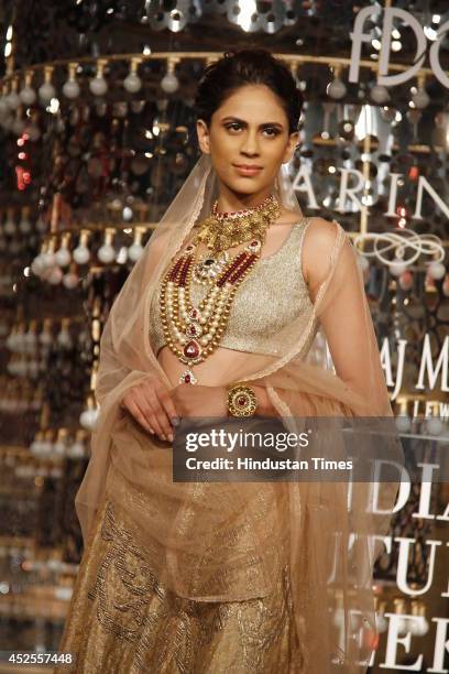 Model walks down the ramp during grand finale by Shree Raj Mahal Jewellers as a part of India Couture Week 2014 at the Taj Palace Hotel on July 20,...